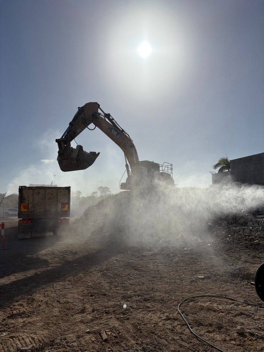 Excavator working through a dust plume at Grand Plaza, Browns Plains